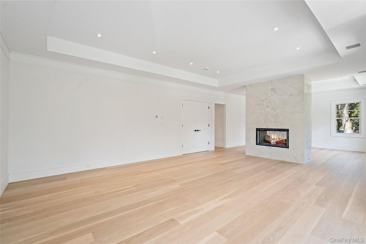 Empty room, Fireplace, Interior, Marble Walls, Recessed Lighting, Wood Texture Flooring