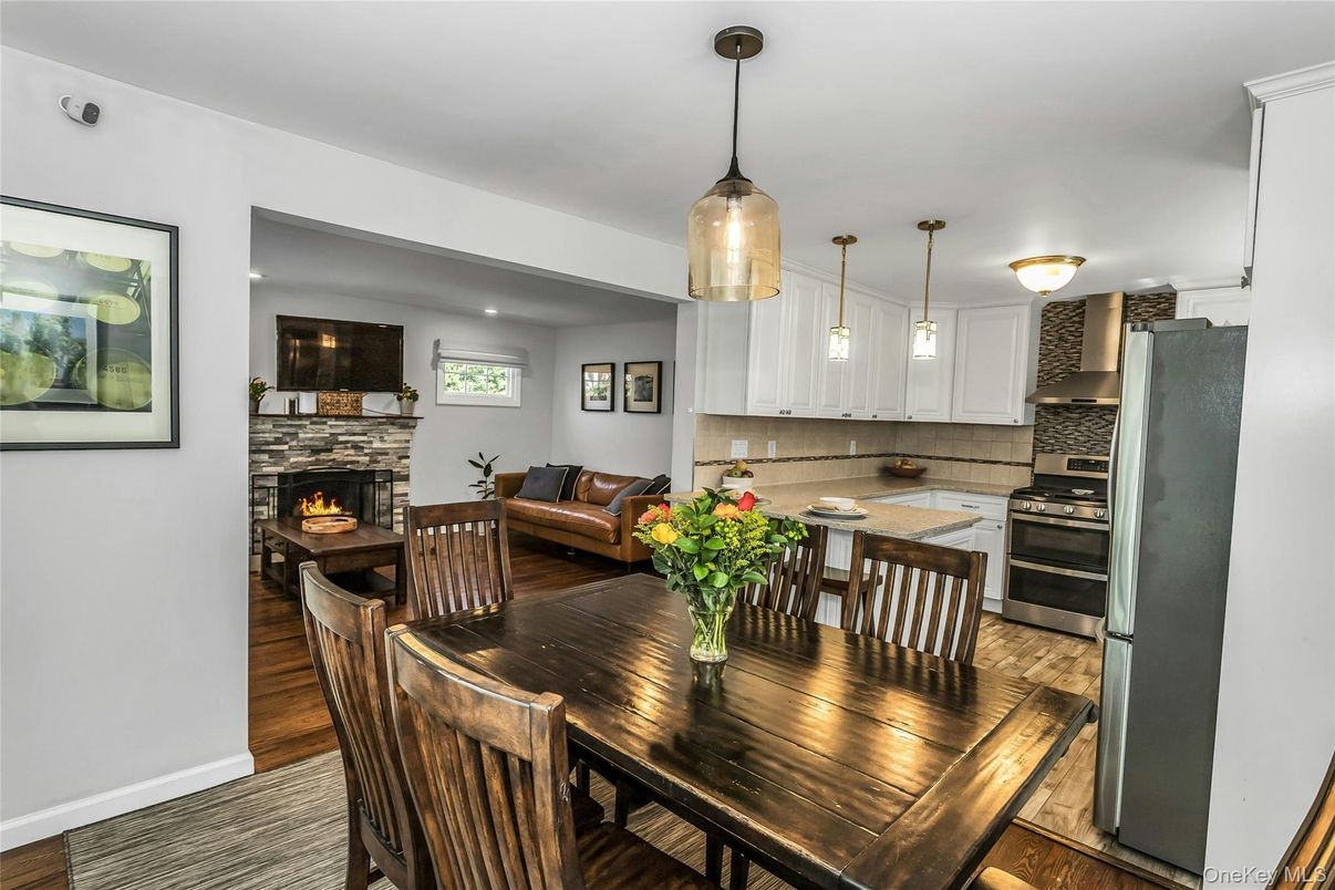 Dining room, Fireplace, Interior, Kitchen, Living room, Pendant Lights, Stainless Steel Appliances, Wood Texture Flooring