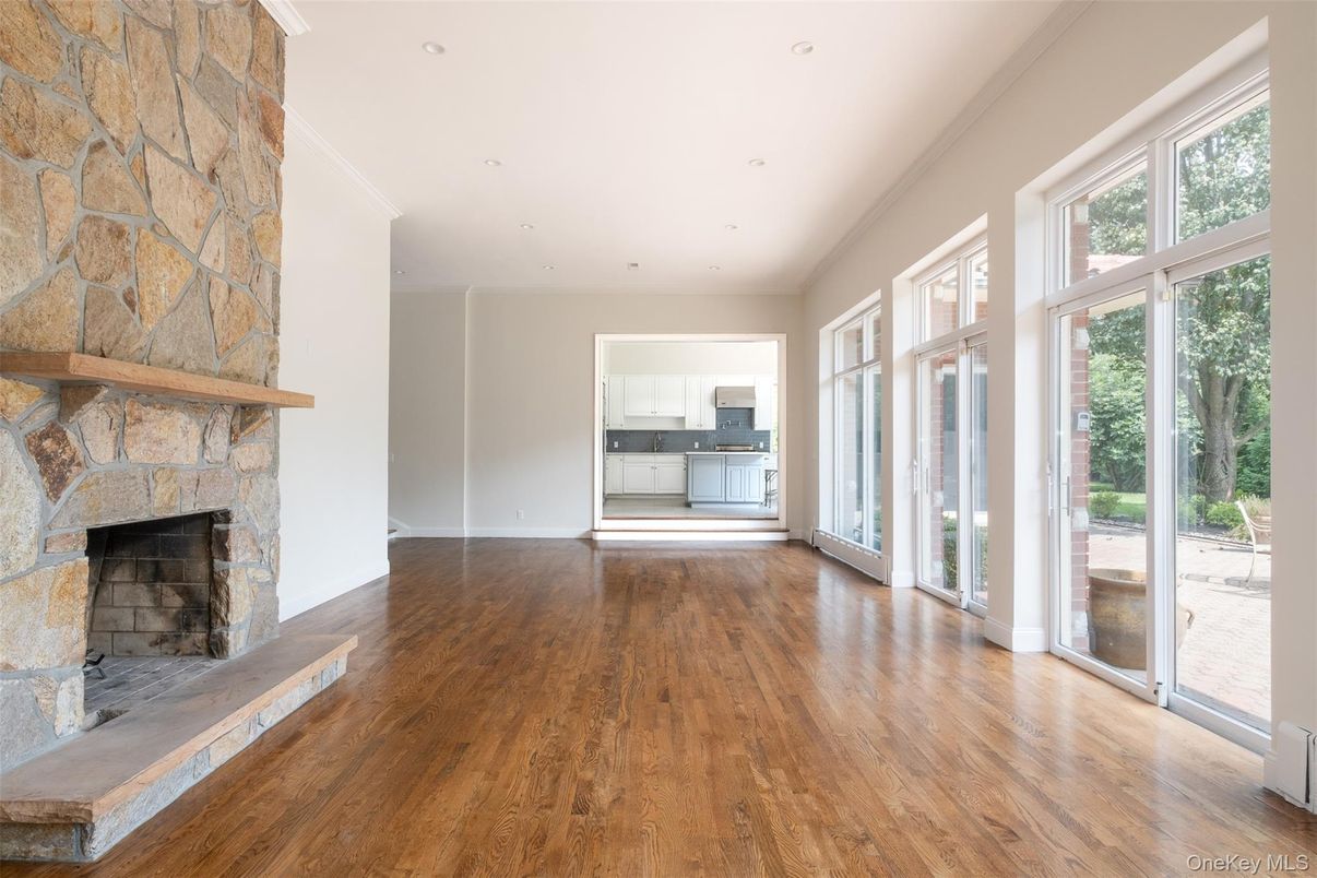 Empty room, Fireplace, Interior, Recessed Lighting, Stone Walls, Wood Texture Flooring