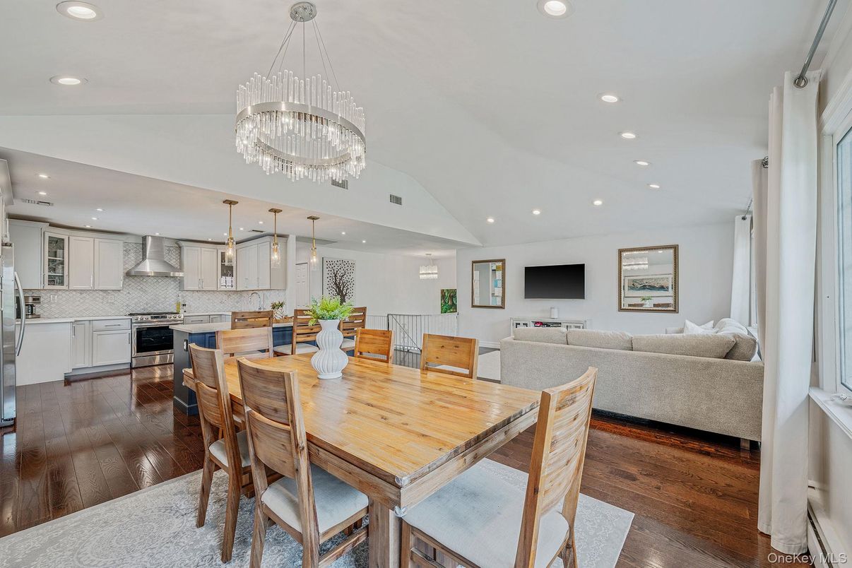 Chandelier, Dining room, Interior, Kitchen, Living room, Pendant Lights, Recessed Lighting, Stainless Steel Appliances, Wood Texture Flooring