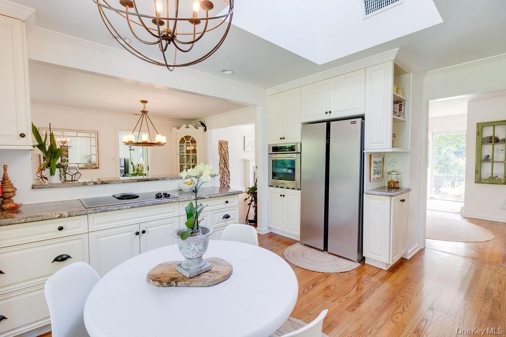 Chandelier, Dining room, Interior, Kitchen, Pendant Lights, Stainless Steel Appliances, Wood Texture Flooring