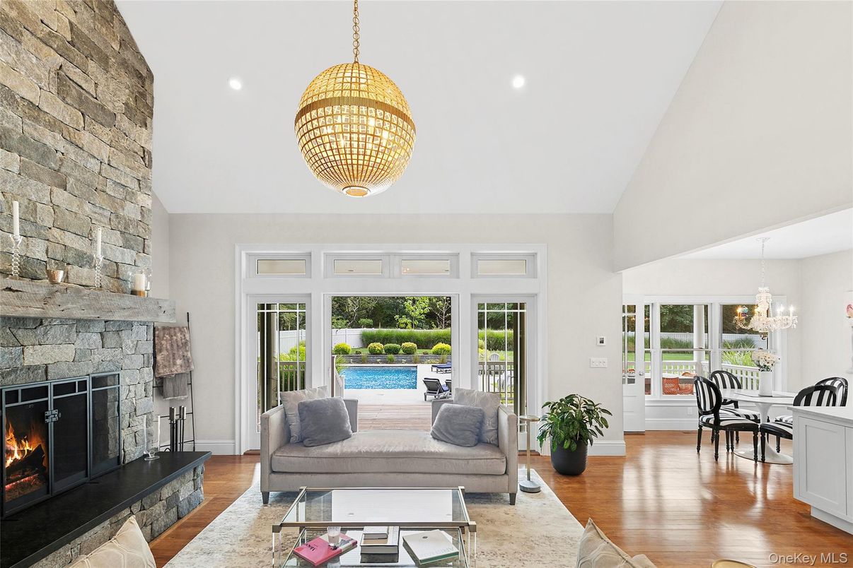 Chandelier, Dining room, Fireplace, Interior, Living room, Pendant Lights, Recessed Lighting, Stone Walls, Wood Texture Flooring
