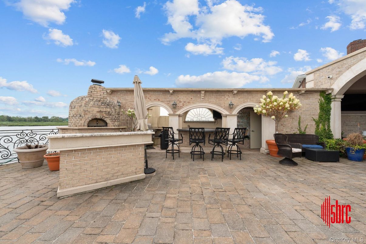 Exterior, Fireplace, Outdoor Kitchen, Water