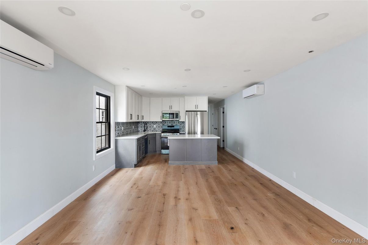 Empty room, Interior, Kitchen, Recessed Lighting, Stainless Steel Appliances, Wood Texture Flooring