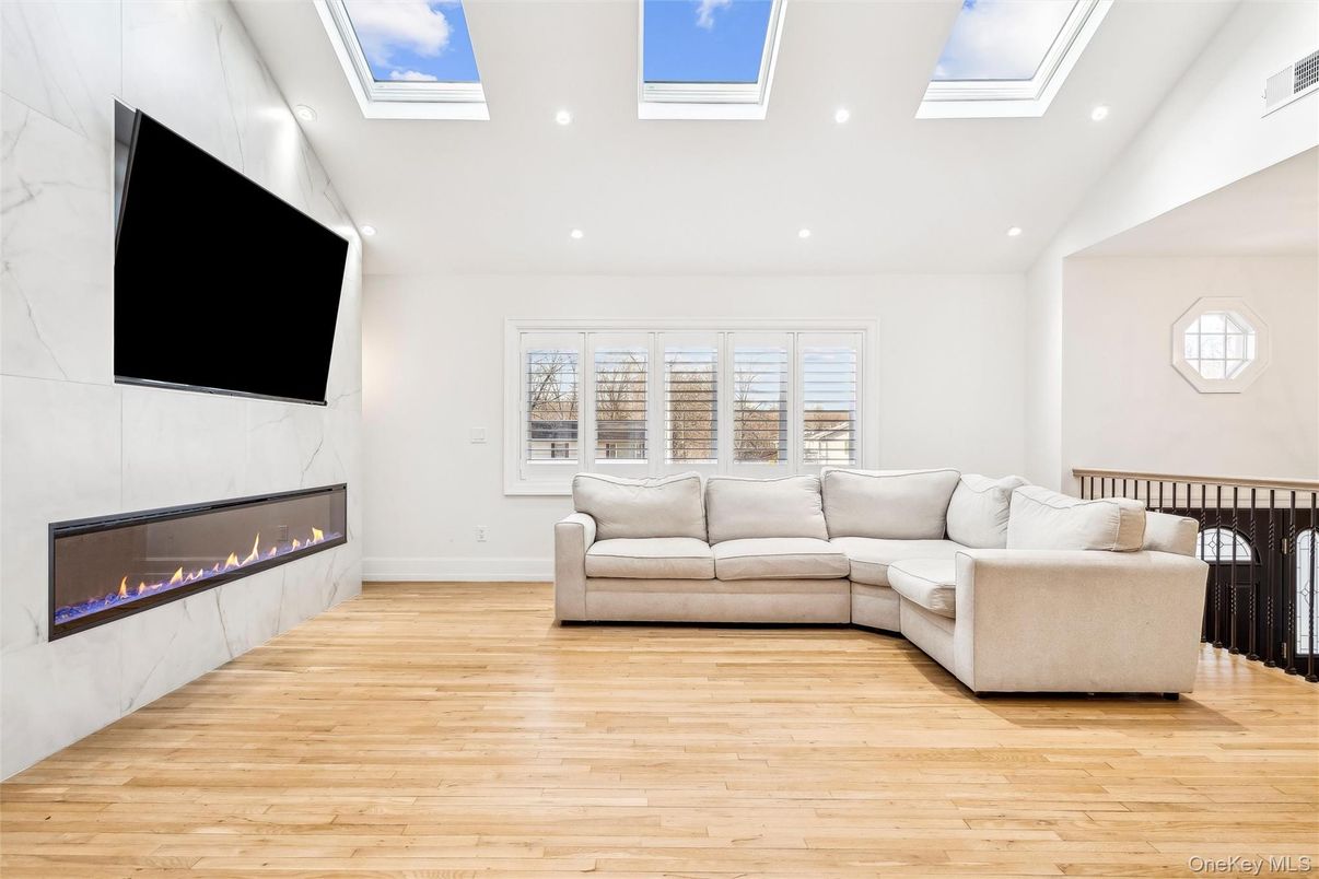 Fireplace, Glass Ceilings, Interior, Living room, Marble Walls, Recessed Lighting, Wood Texture Flooring