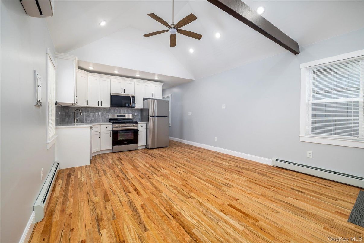 Empty room, Interior, Kitchen, Recessed Lighting, Stainless Steel Appliances, Wood Texture Flooring