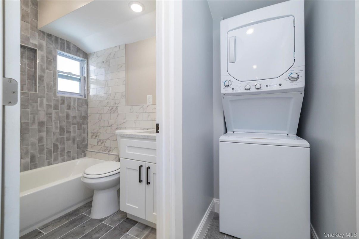 Bathroom, Interior, Marble Walls, Recessed Lighting, Utility Closets, Washer, Wood Texture Flooring