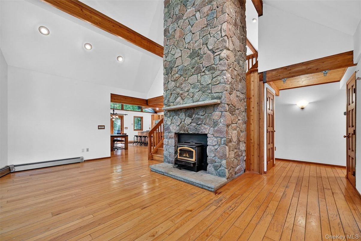 Empty room, Fireplace, Interior, Recessed Lighting, Stone Walls, Wooden Beams, Wood Texture Flooring