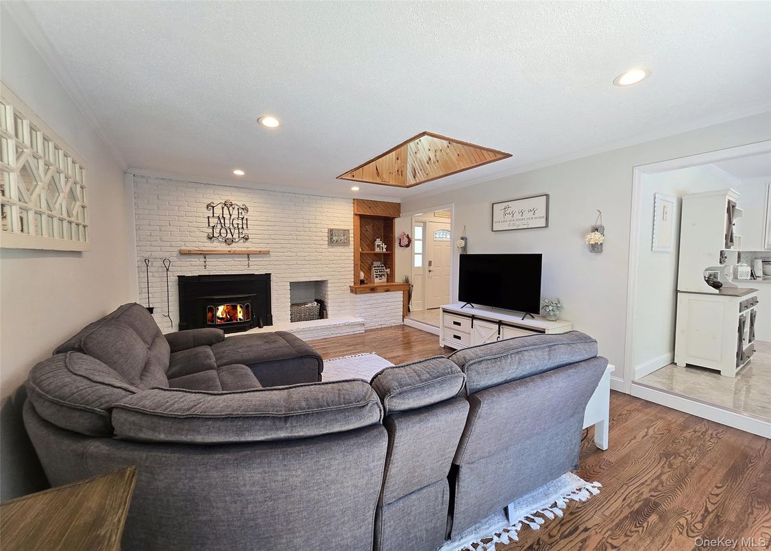 Fireplace, Interior, Living room, Recessed Lighting, Stone Walls, Wood Texture Flooring