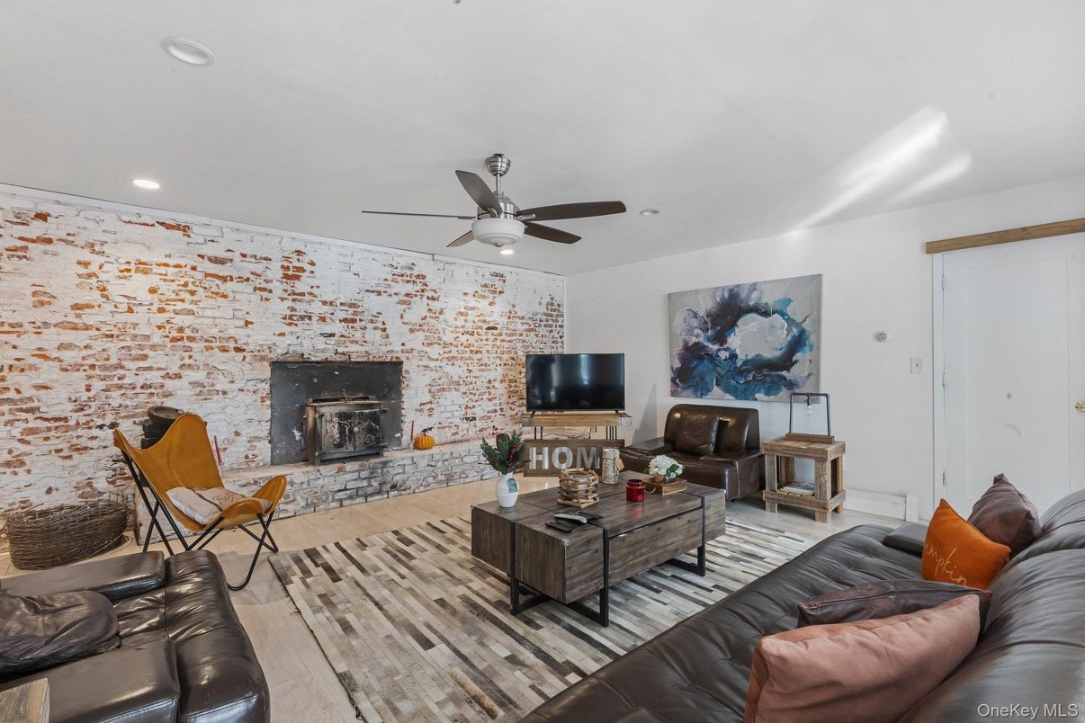 Fireplace, Interior, Living room, Recessed Lighting, Stone Walls, Wood Texture Flooring