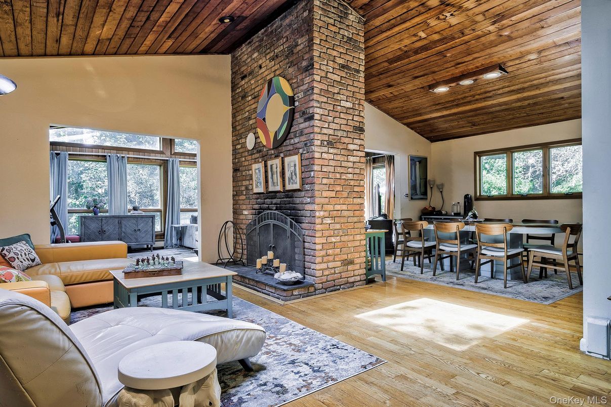 Dining room, Fireplace, Interior, Living room, Recessed Lighting, Stone Walls, Wooden Ceilings, Wood Texture Flooring