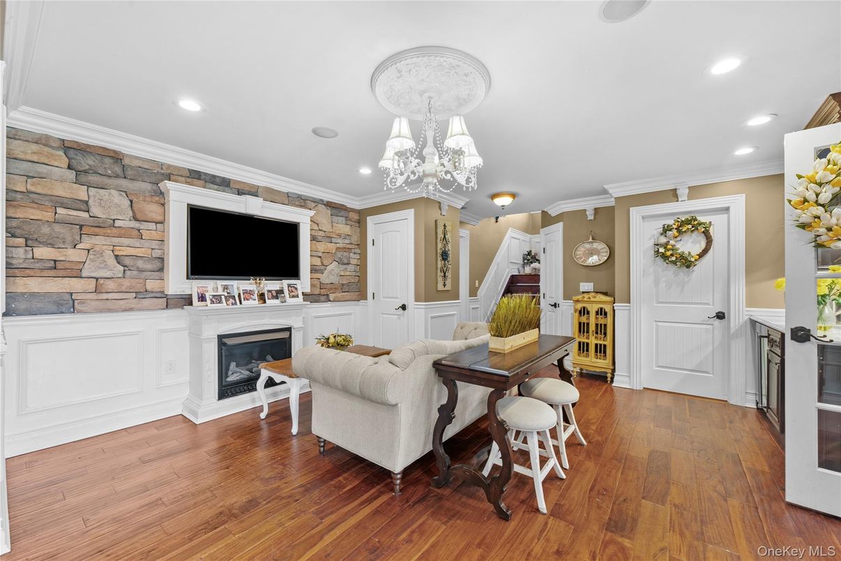 Chandelier, Fireplace, Interior, Recessed Lighting, Stone Walls, Wood Texture Flooring