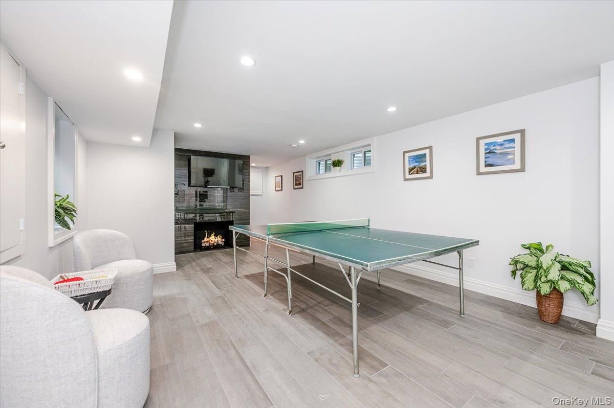 Fireplace, Game Room, Interior, Recessed Lighting, Wood Texture Flooring