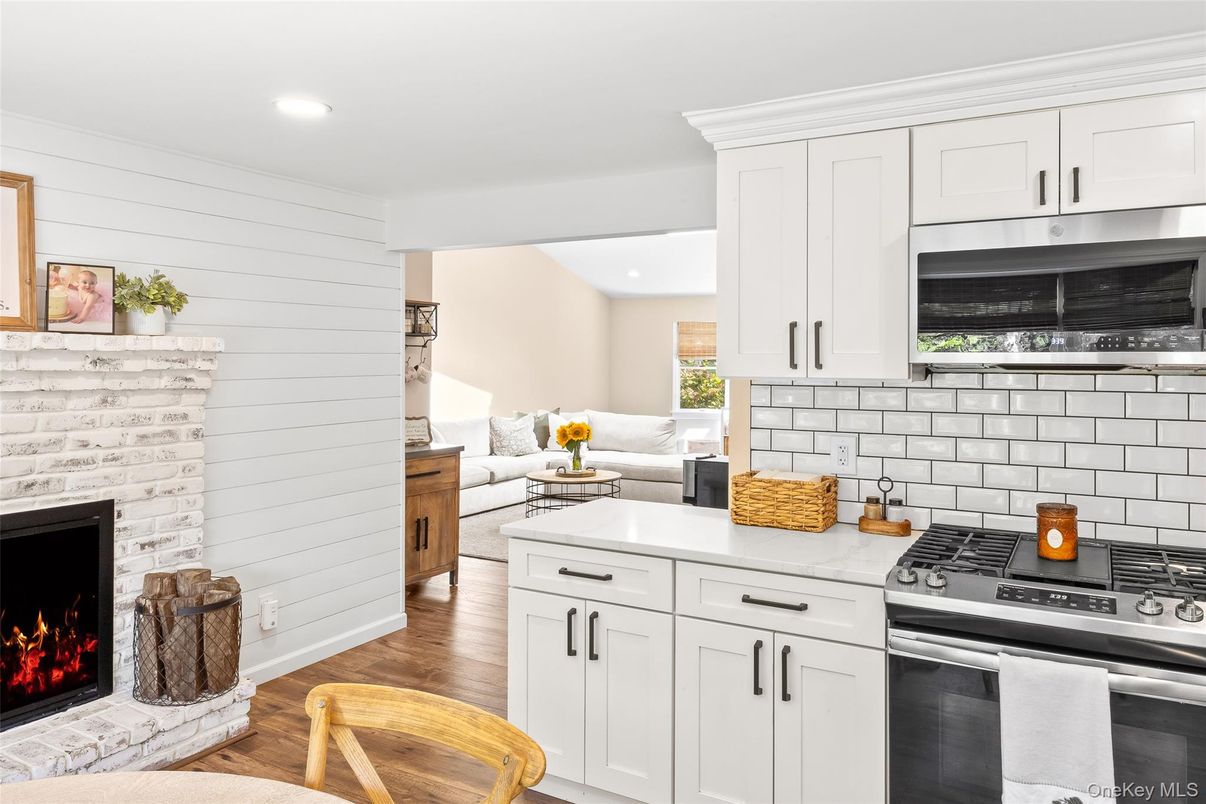 Fireplace, Interior, Kitchen, Living room, Recessed Lighting, Stainless Steel Appliances, Wood Texture Flooring