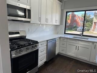 Interior, Kitchen, Marble Walls, Recessed Lighting, Stainless Steel Appliances, Wood Texture Flooring