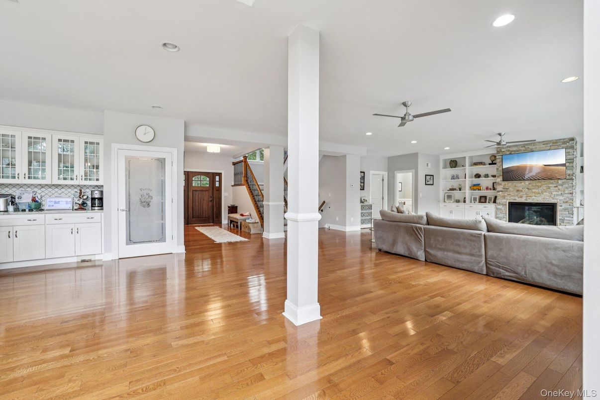 Fireplace, Interior, Living room, Recessed Lighting, Stone Walls, Wood Texture Flooring
