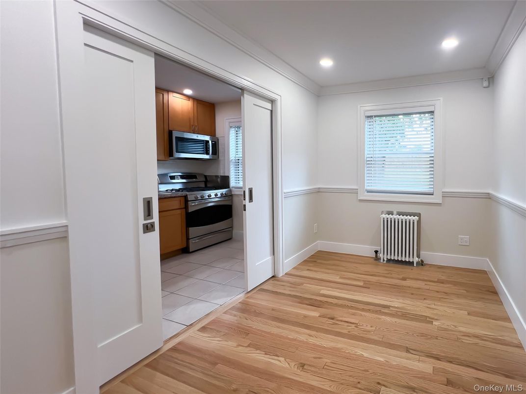 Empty room, Interior, Kitchen, Recessed Lighting, Stainless Steel Appliances, Wood Texture Flooring
