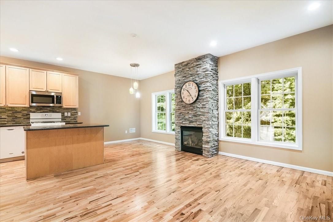 Empty room, Fireplace, Interior, Kitchen, Pendant Lights, Recessed Lighting, Stone Walls, Wood Texture Flooring