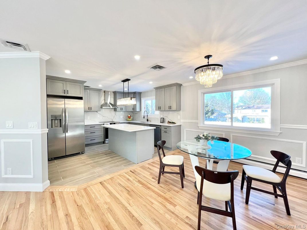 Chandelier, Dining room, Interior, Kitchen, Pendant Lights, Recessed Lighting, Stainless Steel Appliances, Wood Texture Flooring