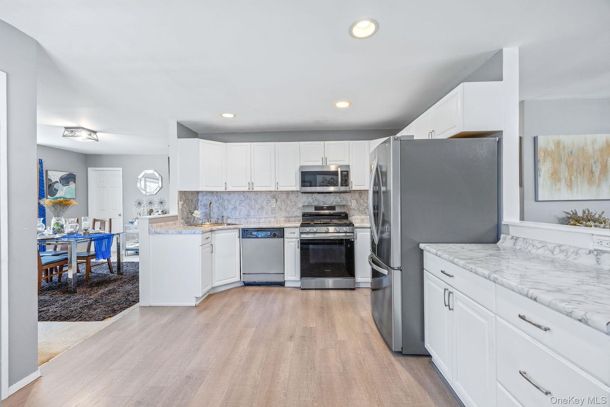 Dining room, Interior, Kitchen, Recessed Lighting, Stainless Steel Appliances, Wood Texture Flooring