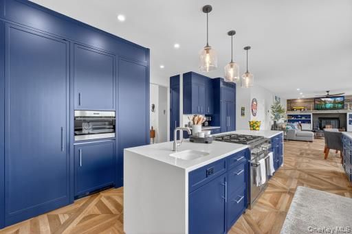 Fireplace, Interior, Kitchen, Living room, Pendant Lights, Recessed Lighting, Stainless Steel Appliances, Wood Texture Flooring
