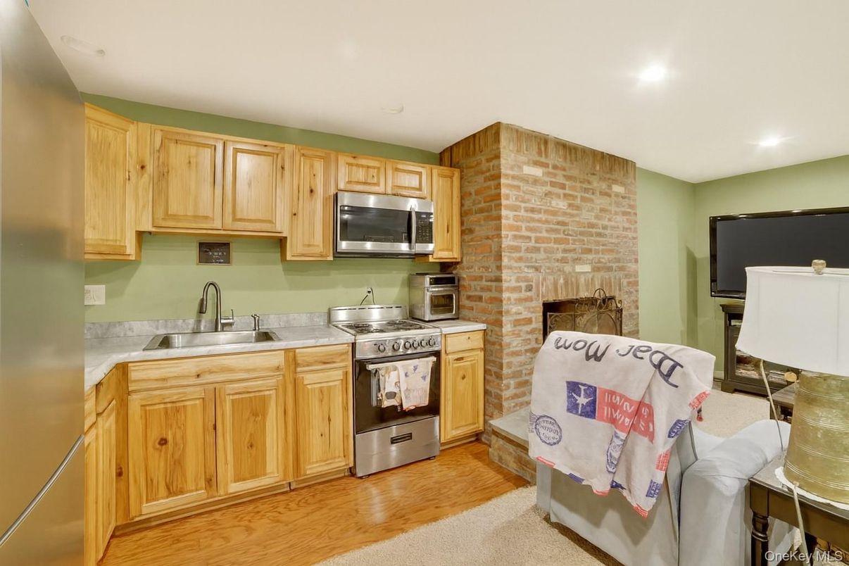 Fireplace, Interior, Kitchen, Recessed Lighting, Stainless Steel Appliances, Stone Walls, Wood Texture Flooring