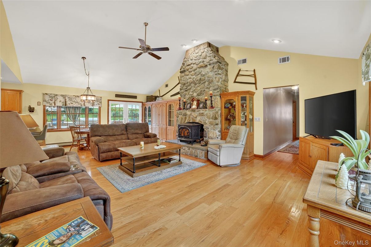 Dining room, Fireplace, Interior, Living room, Pendant Lights, Recessed Lighting, Stone Walls, Wood Texture Flooring