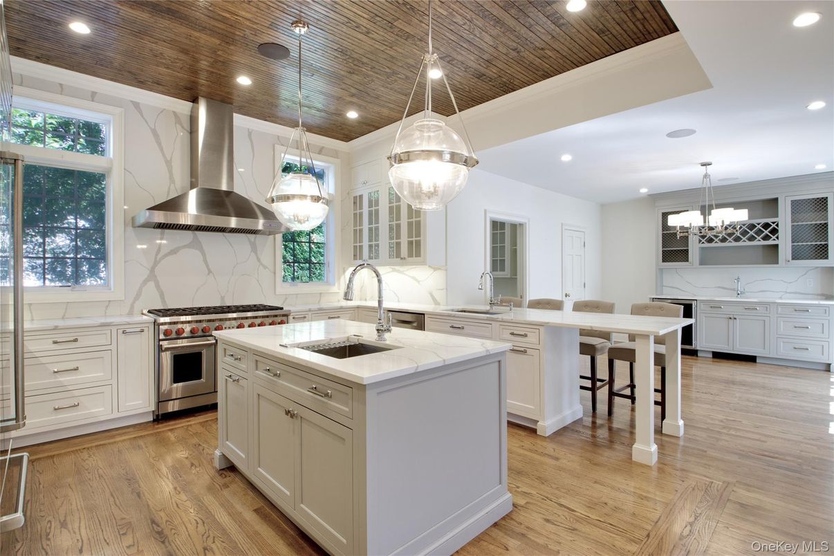 Chandelier, Interior, Kitchen, Marble Walls, Pendant Lights, Recessed Lighting, Stainless Steel Appliances, Wooden Ceilings, Wood Texture Flooring