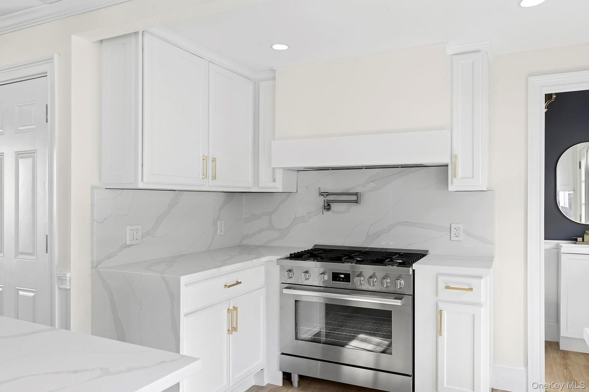 Interior, Kitchen, Marble Walls, Recessed Lighting, Stainless Steel Appliances, Wood Texture Flooring