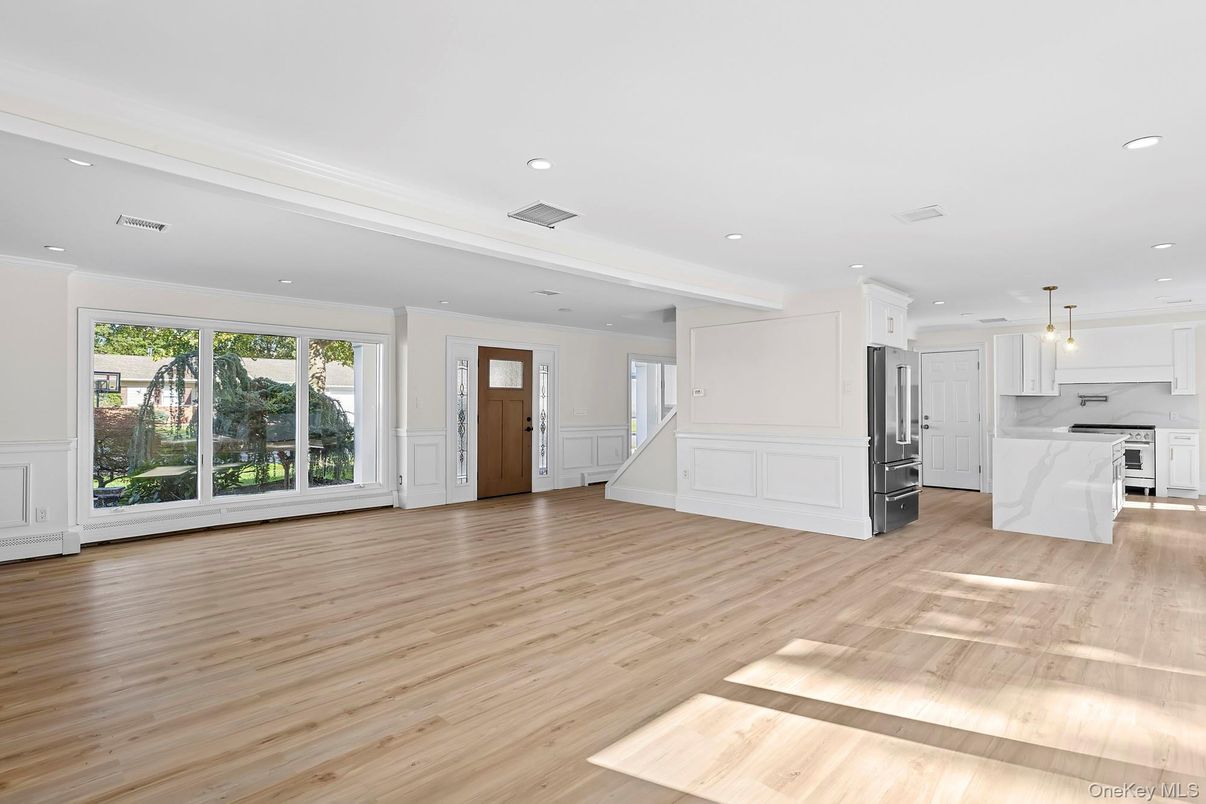 Empty room, Interior, Kitchen, Pendant Lights, Recessed Lighting, Stainless Steel Appliances, Wood Texture Flooring