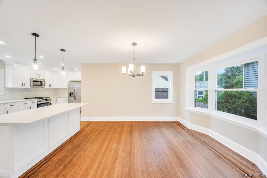 Empty room, Interior, Kitchen, Pendant Lights, Recessed Lighting, Stainless Steel Appliances, Wood Texture Flooring