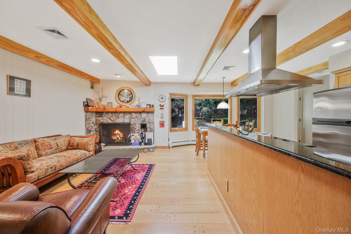 Fireplace, Interior, Living room, Pendant Lights, Recessed Lighting, Stainless Steel Appliances, Wooden Beams, Wood Texture Flooring