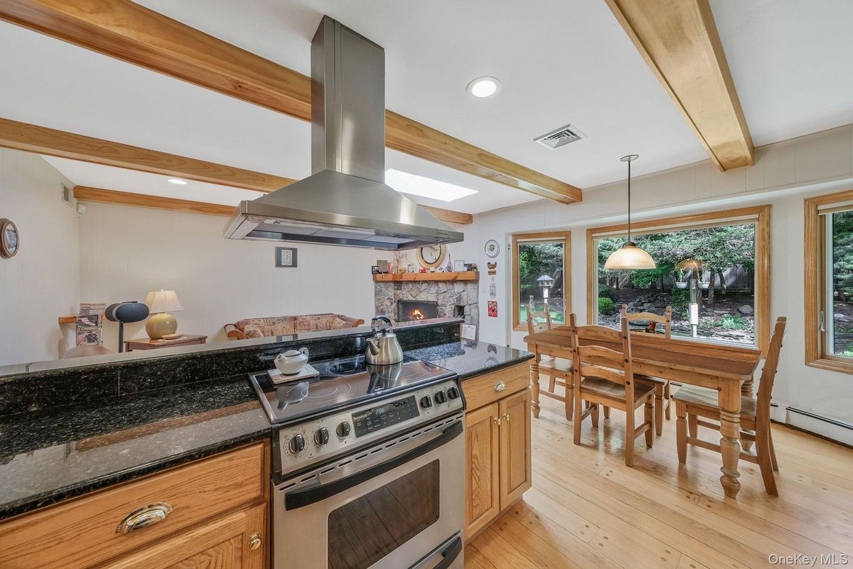 Dining room, Fireplace, Interior, Kitchen, Pendant Lights, Recessed Lighting, Stainless Steel Appliances, Wooden Beams, Wood Texture Flooring
