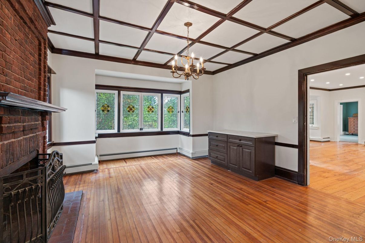 Chandelier, Empty room, Fireplace, Interior, Recessed Lighting, Stone Walls, Wood Texture Flooring