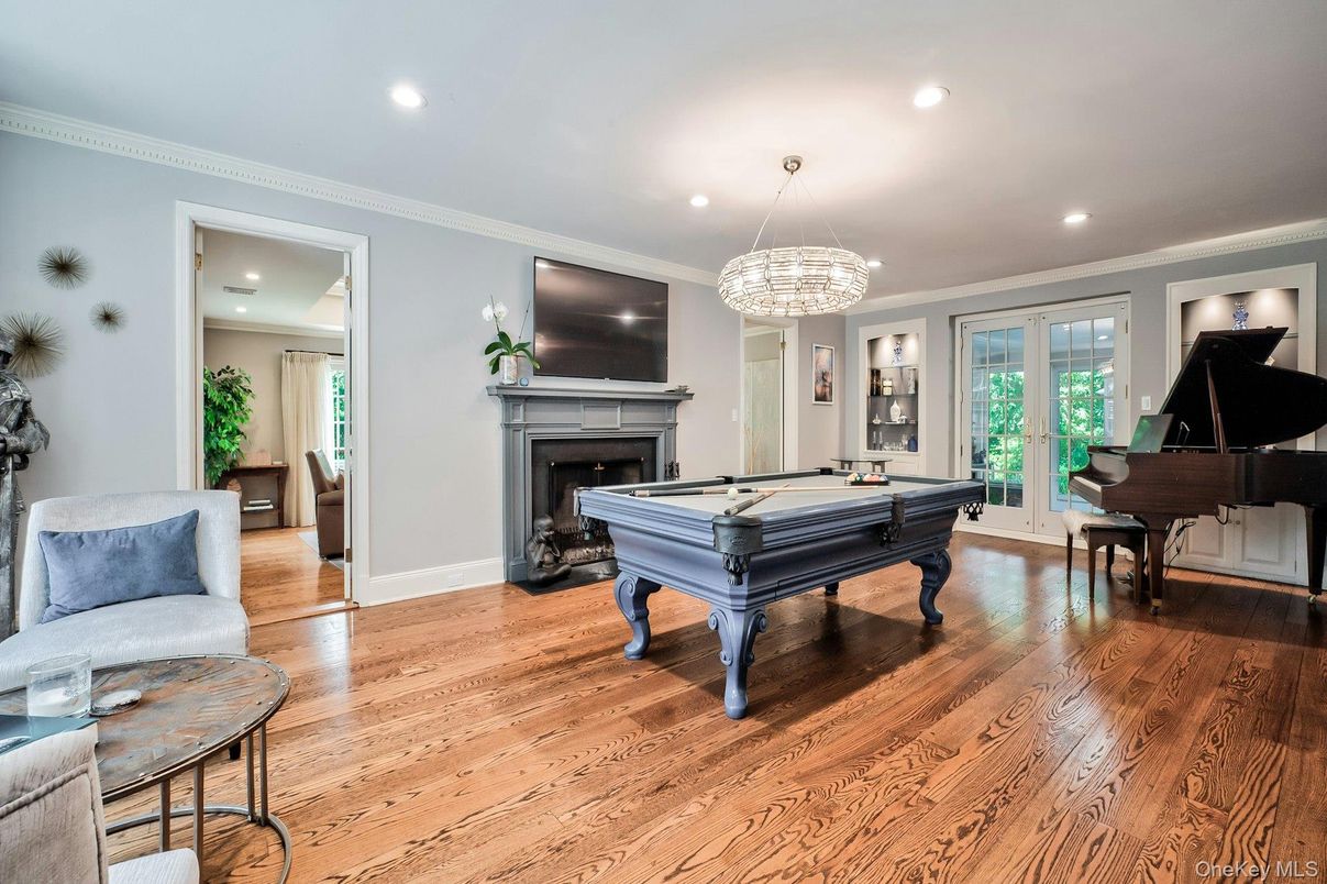 Billiard Table, Chandelier, Fireplace, Game Room, Interior, Piano, Recessed Lighting, Wood Texture Flooring