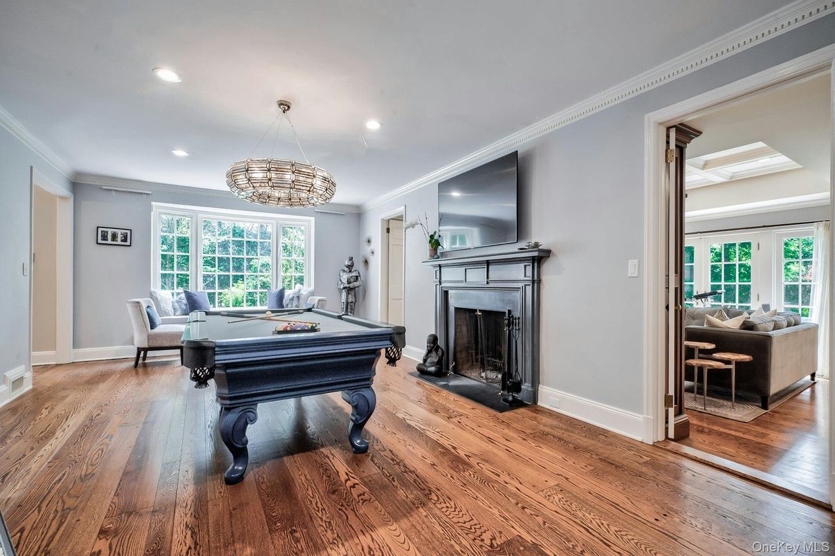 Billiard Table, Chandelier, Fireplace, Game Room, Interior, Recessed Lighting, Wood Texture Flooring