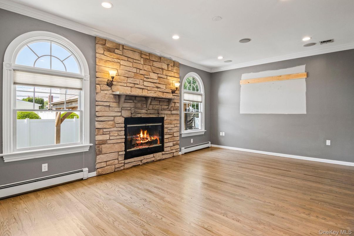 Empty room, Fireplace, Interior, Recessed Lighting, Stone Walls, Wood Texture Flooring