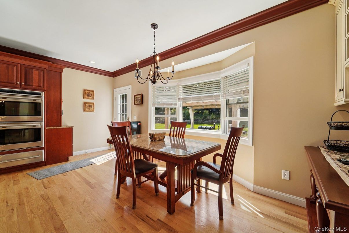 Chandelier, Dining room, Interior, Kitchen, Recessed Lighting, Stainless Steel Appliances, Wood Texture Flooring
