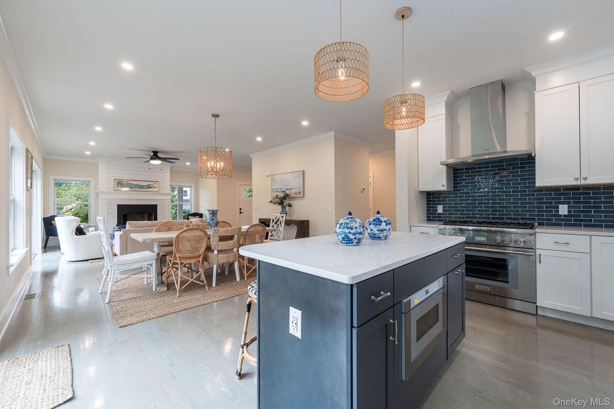 Chandelier, Dining room, Fireplace, Interior, Kitchen, Living room, Pendant Lights, Recessed Lighting, Stainless Steel Appliances, Wood Texture Flooring