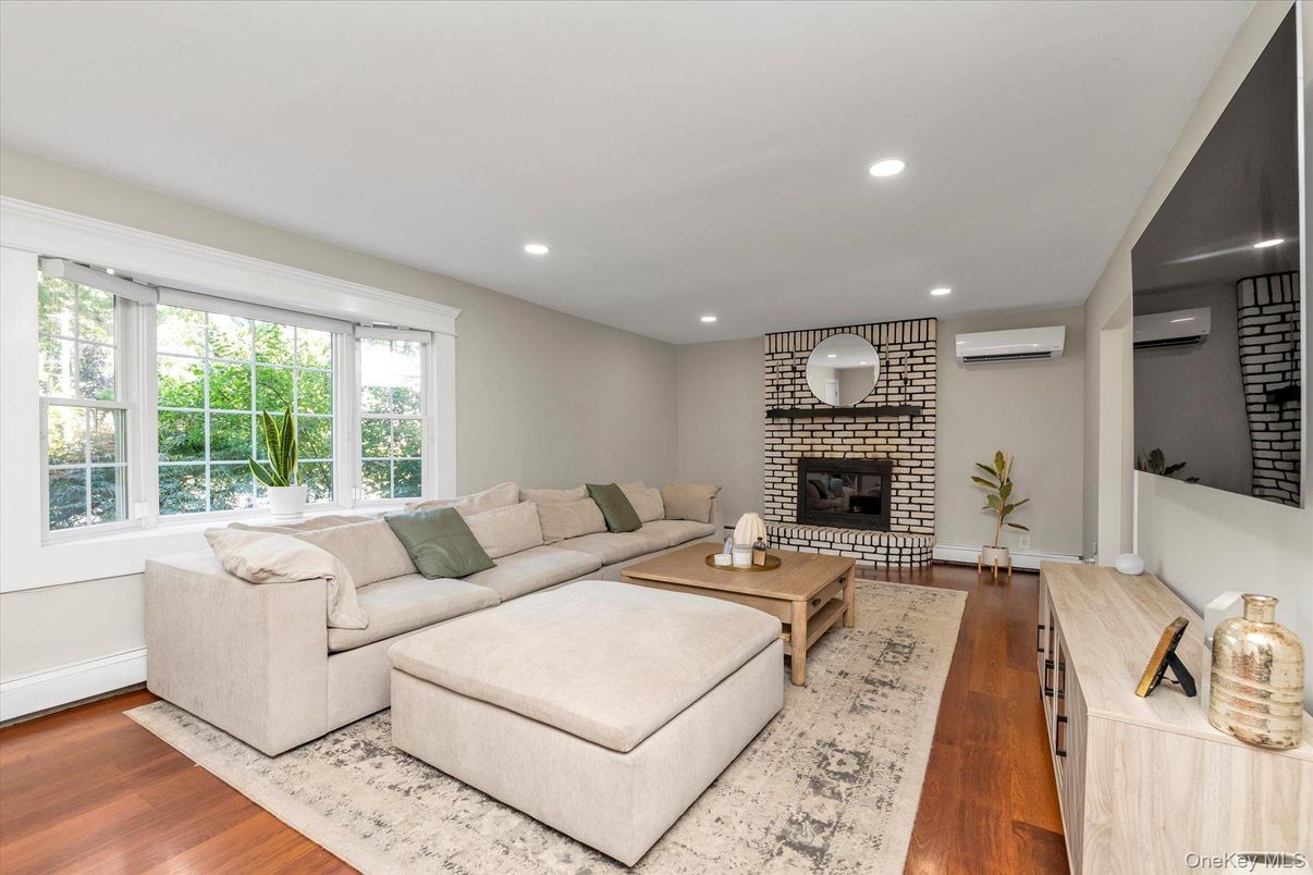 Fireplace, Interior, Living room, Recessed Lighting, Stone Walls, Wood Texture Flooring