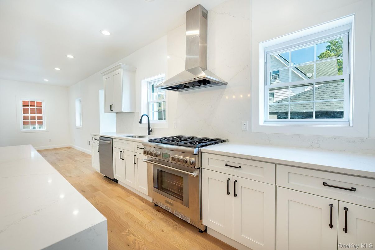 Interior, Kitchen, Marble Walls, Recessed Lighting, Stainless Steel Appliances, Wood Texture Flooring