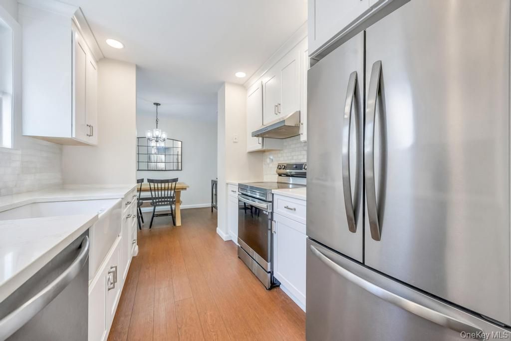 Chandelier, Dining room, Interior, Kitchen, Recessed Lighting, Stainless Steel Appliances, Wood Texture Flooring