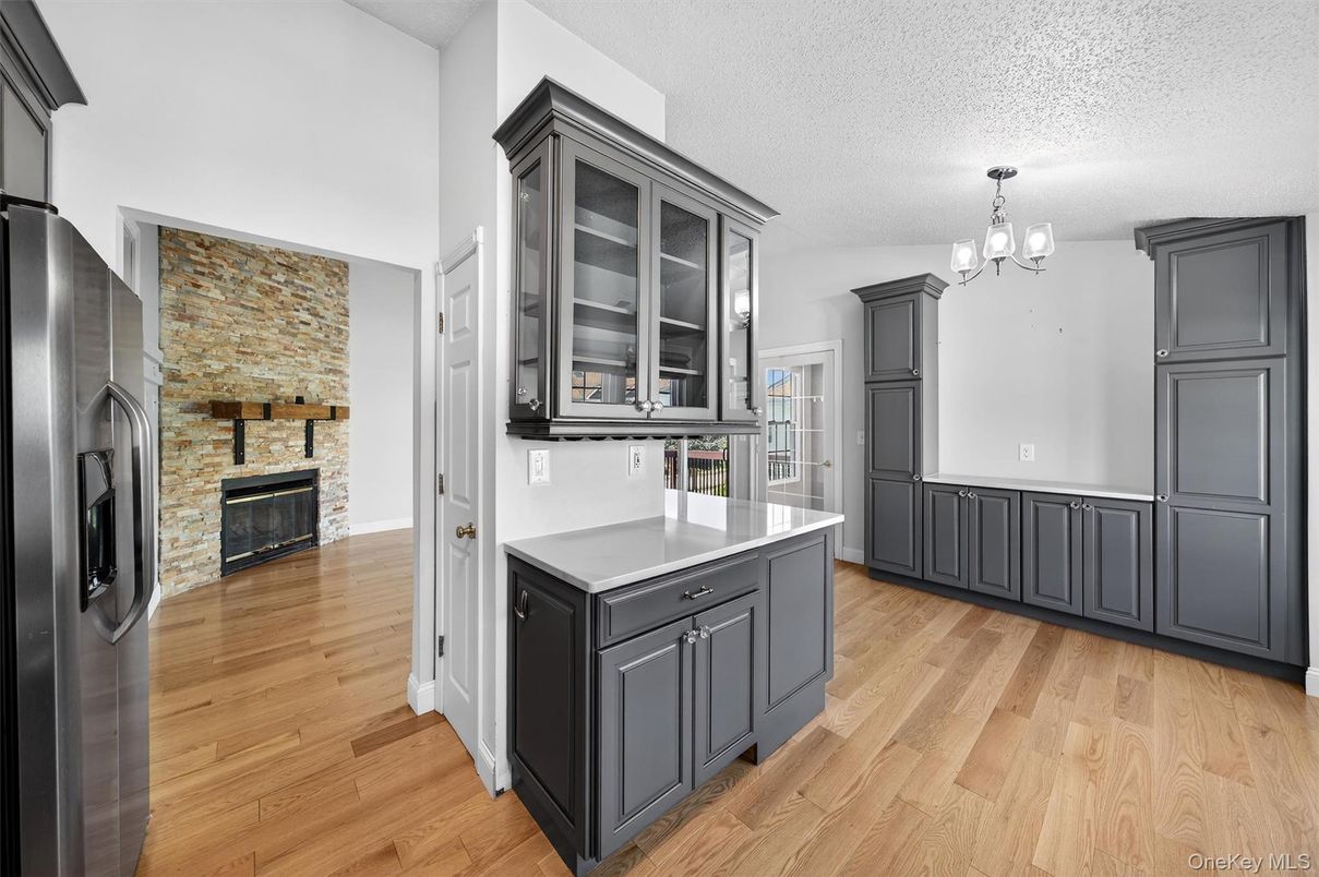 Chandelier, Fireplace, Interior, Kitchen, Stone Walls, Wood Texture Flooring