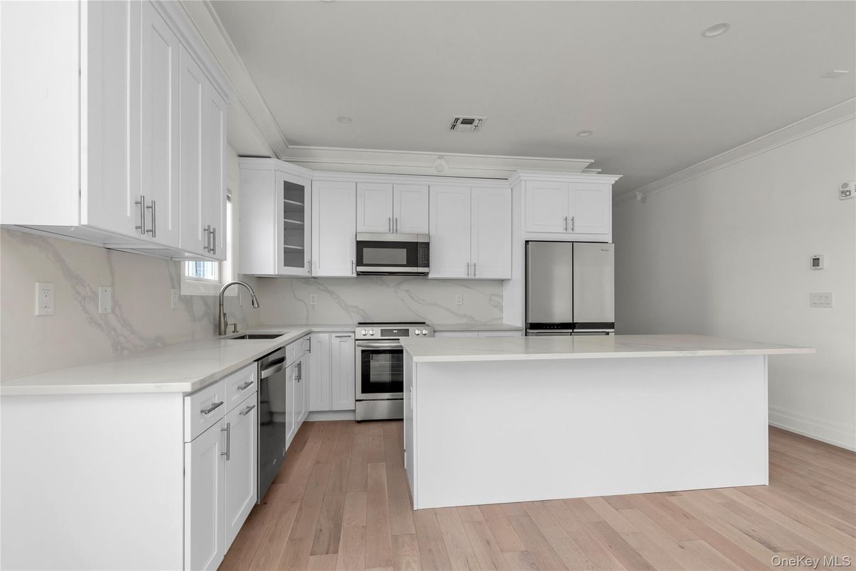 Interior, Kitchen, Marble Walls, Recessed Lighting, Stainless Steel Appliances, Wood Texture Flooring