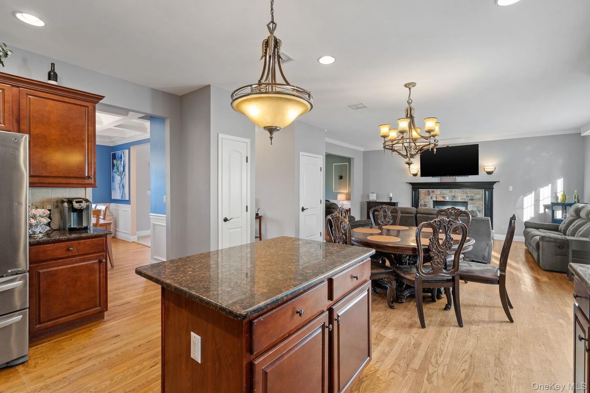 Chandelier, Dining room, Fireplace, Interior, Kitchen, Recessed Lighting, Wood Texture Flooring