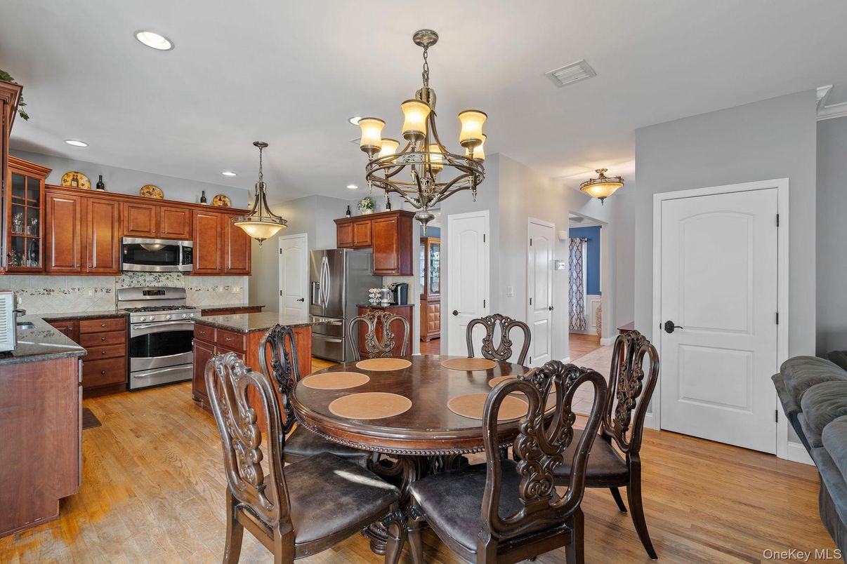 Chandelier, Dining room, Interior, Kitchen, Pendant Lights, Recessed Lighting, Stainless Steel Appliances, Wood Texture Flooring