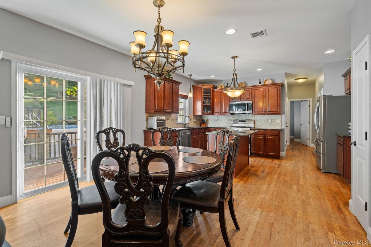 Chandelier, Dining room, Interior, Kitchen, Recessed Lighting, Stainless Steel Appliances, Wood Texture Flooring