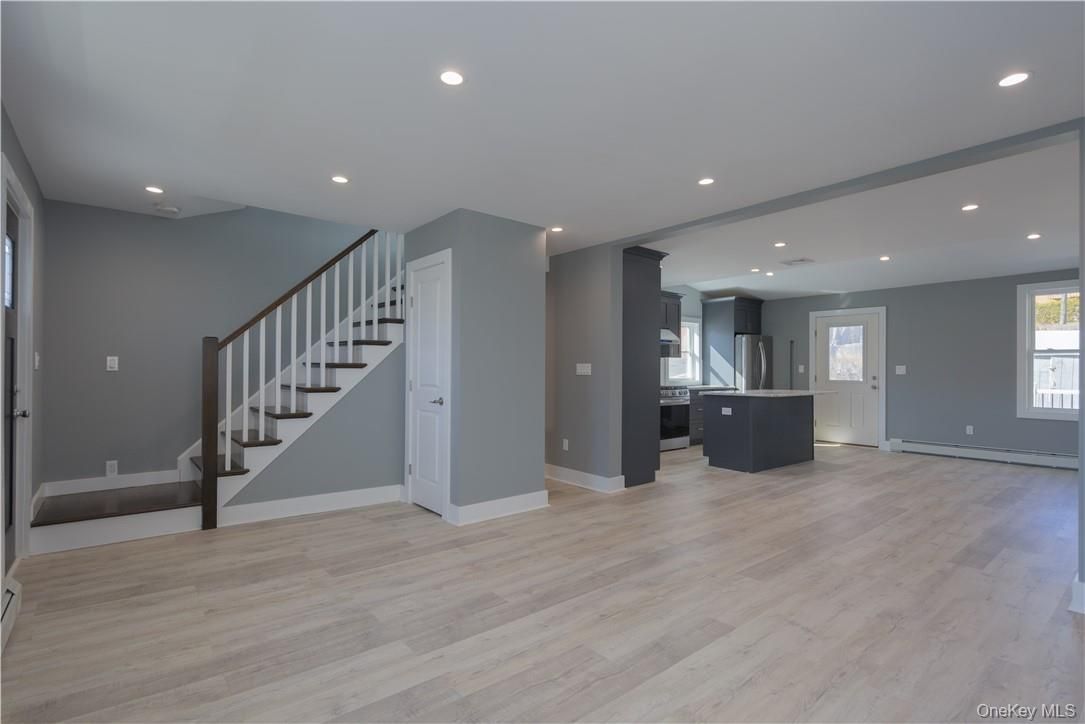 Empty room, Interior, Kitchen, Recessed Lighting, Stainless Steel Appliances, Wood Texture Flooring
