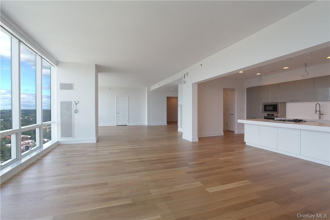 Empty room, Interior, Kitchen, Recessed Lighting, Stainless Steel Appliances, Wood Texture Flooring
