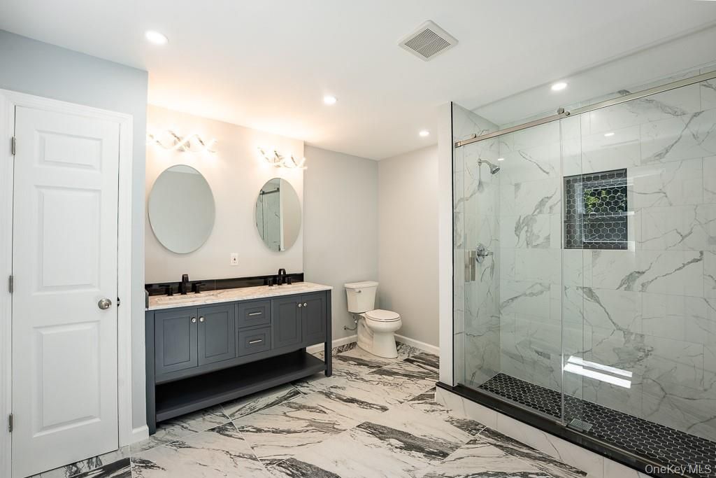 Bathroom, Dual Sink Vanities, Glass Shower, Interior, Marble, Marble Walls, Recessed Lighting